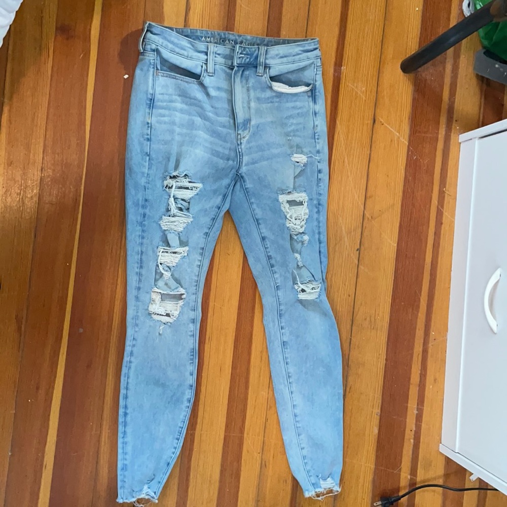 Three pairs of light America eagle jeans